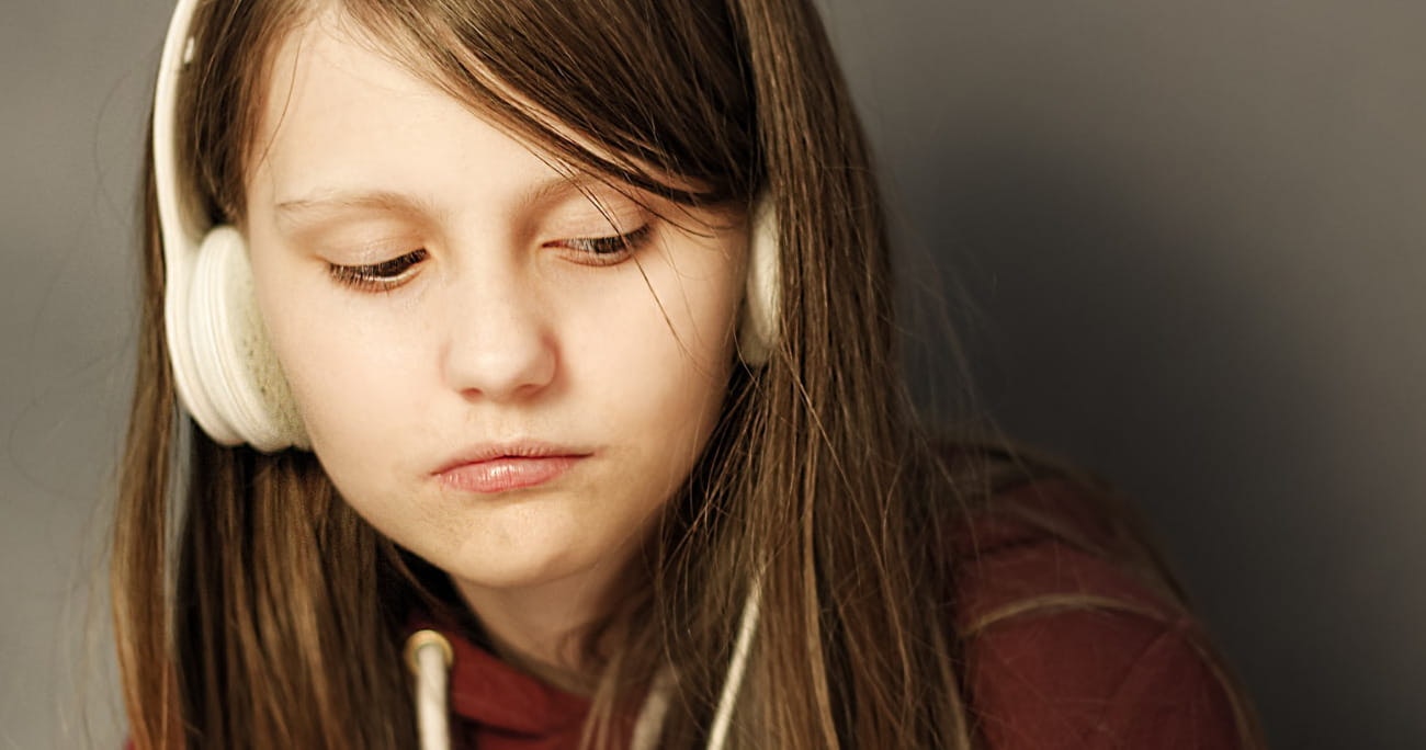 teenager girl listening to music with headphones