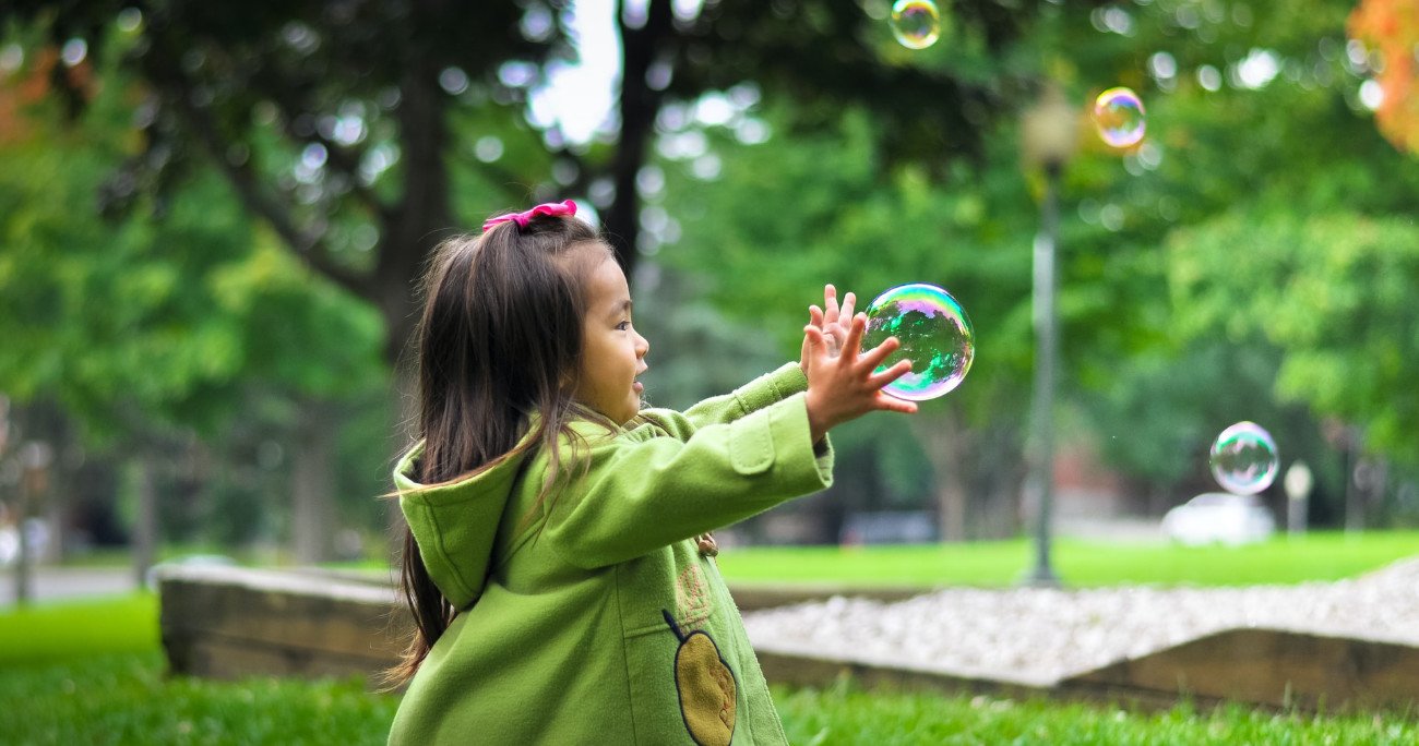 Young child catching a bubble