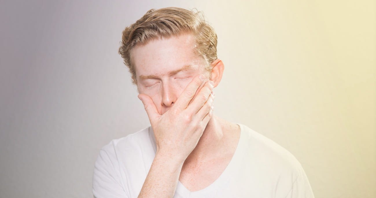 A man holding his face in discouragement