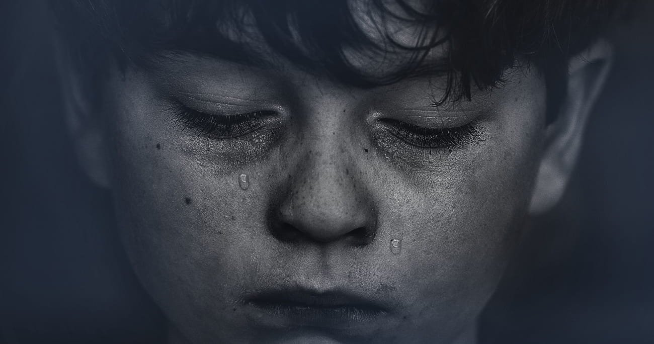 closeup of young boy crying