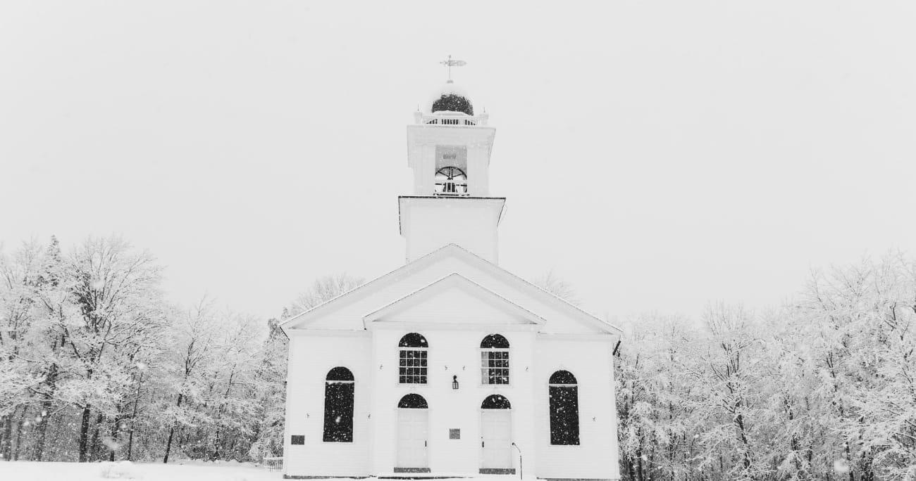 church in the middle of a snowy field