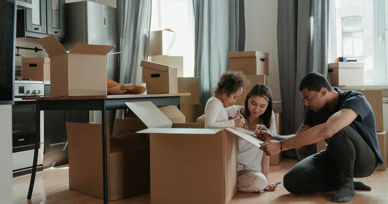 Family with moving boxes in the living room