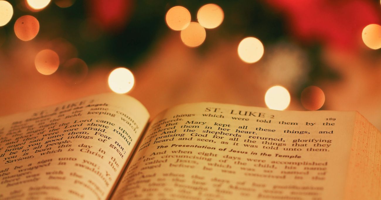 Bible with Christmas tree in the background