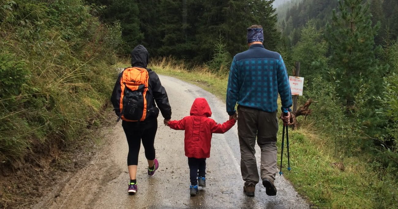 dad, mom, and child on a walking path